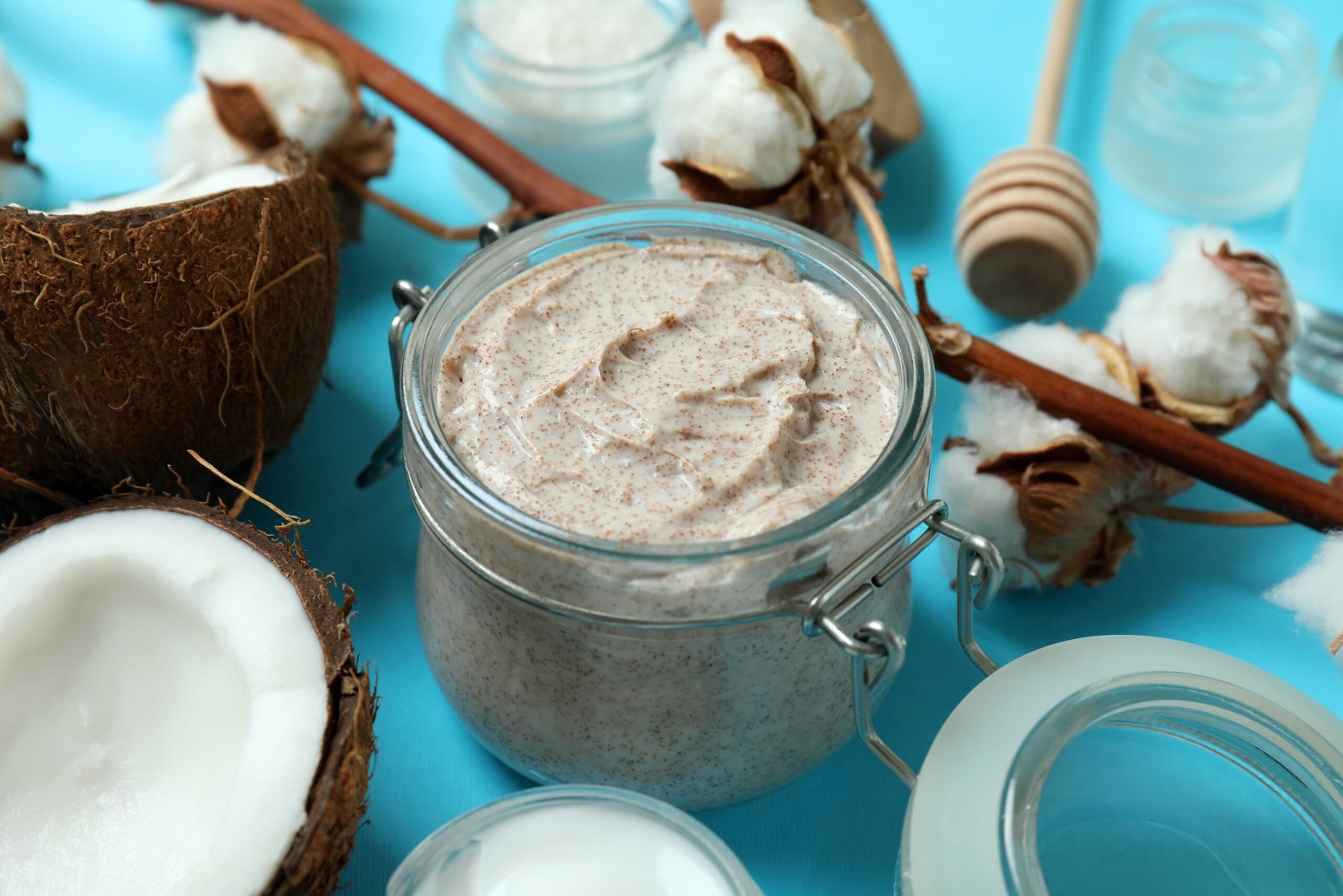 Skin care scrub products arranged on a calming blue background, emphasizing exfoliation and rejuvenation